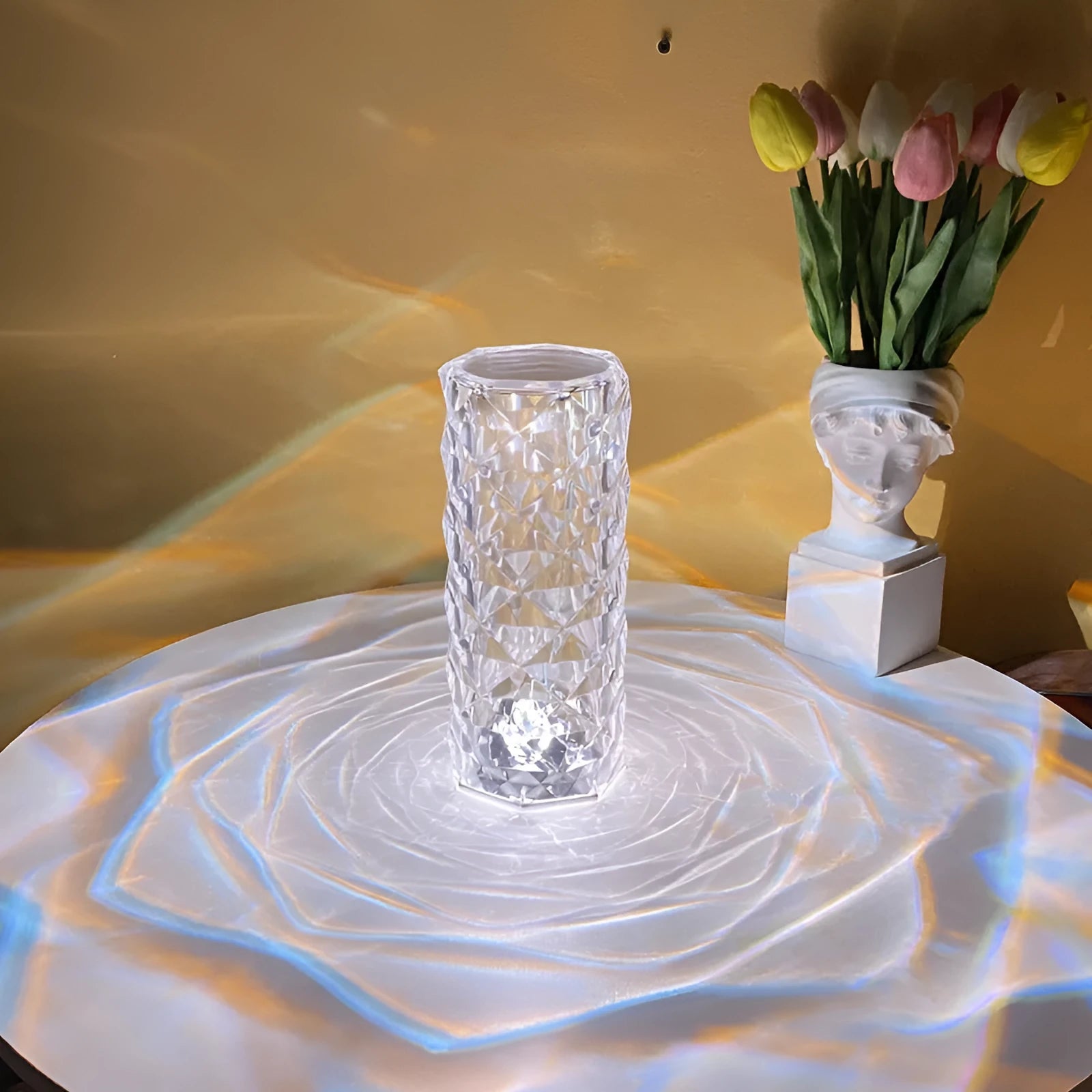 Clear acrylic rose-shaped LED table lamp with touch controls on a wooden surface.