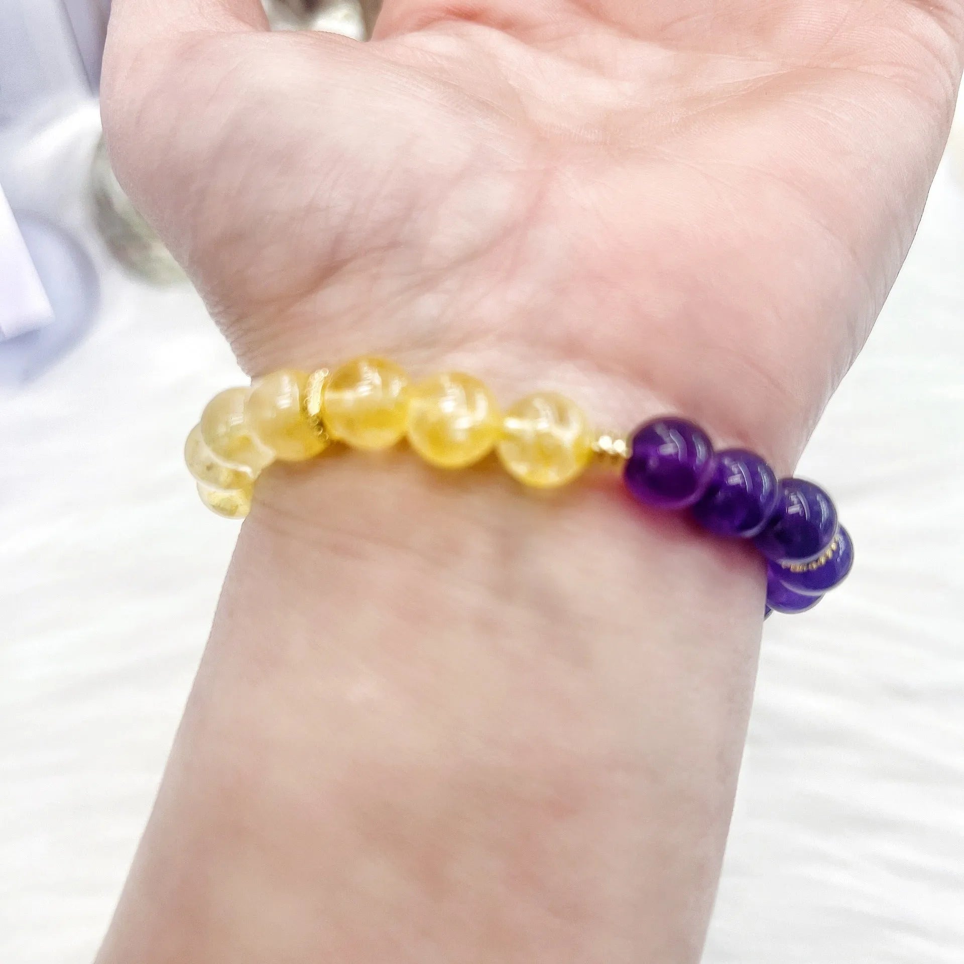 Handmade women's crystal bracelet with yellow and purple amethyst stones, manual craftsmanship