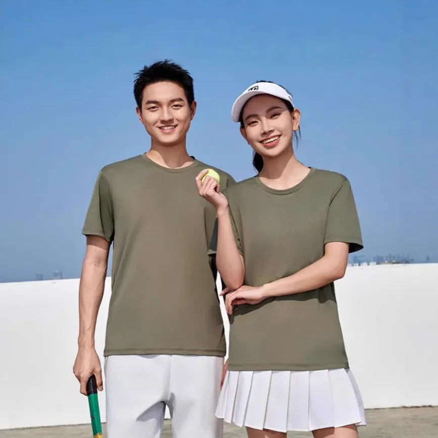 Men's loose fit solid colour polyester sports t-shirt on a hanger, shown in coral pink.