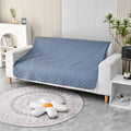 Reversible waterproof dog blanket sofa cover in grey, laid flat on a sofa