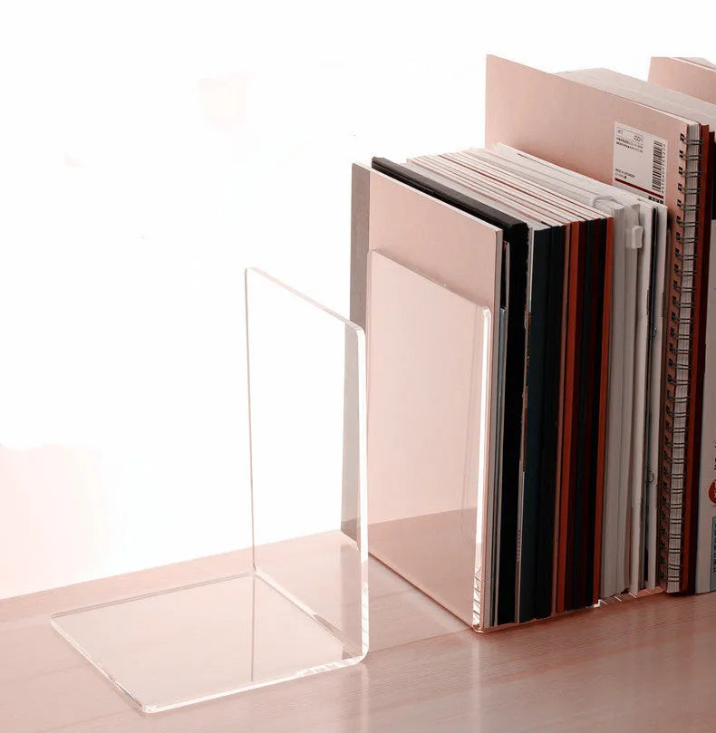 Clear transparent acrylic bookshelf holding a small number of books on a desk