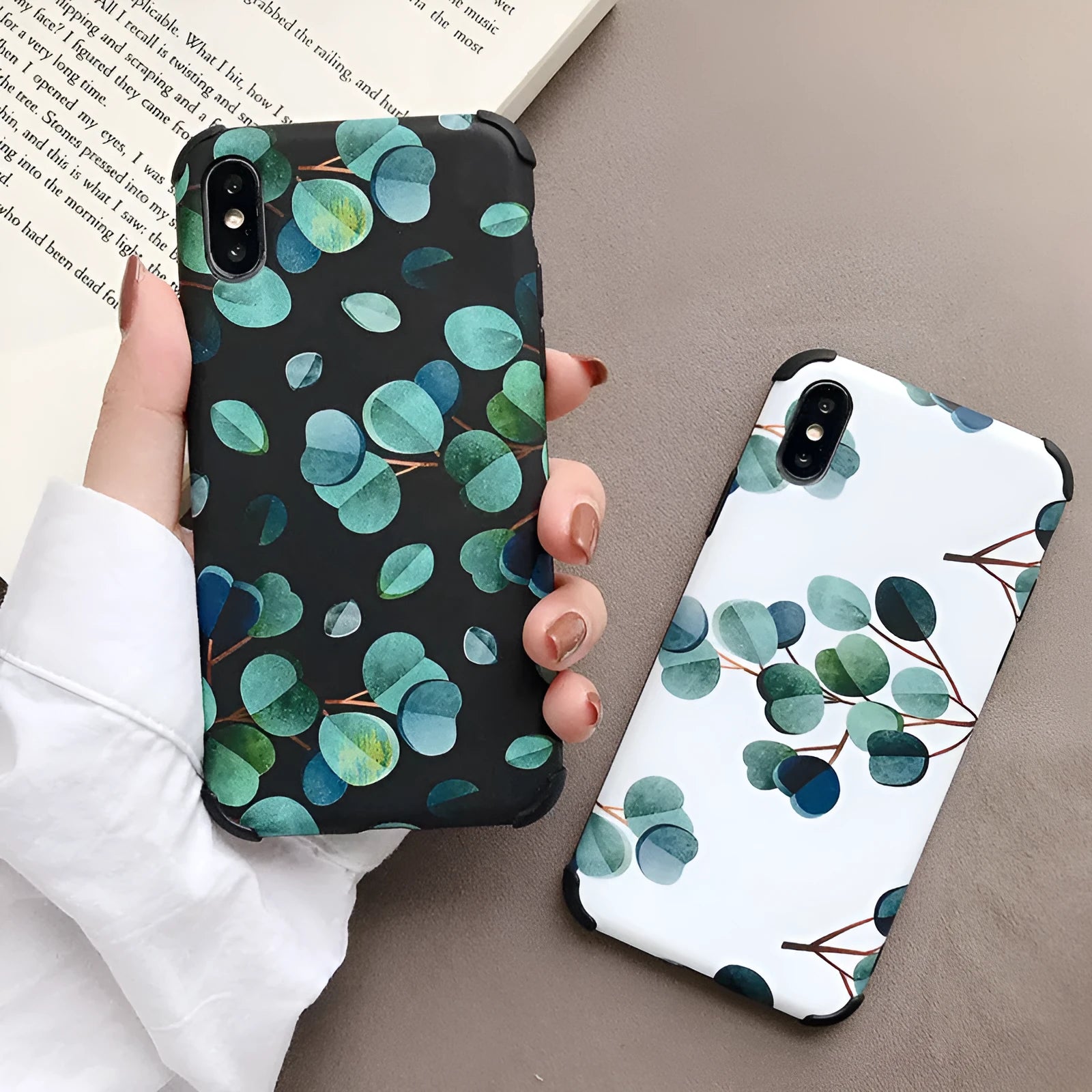 Black silicone iPhone case with a green leaf and botanical floral print design.