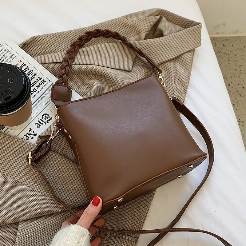 Fashion retro one-shoulder crossbody underarm bucket bag in woven PU with adjustable strap, shown in khaki colour.