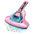 Pink handheld electric vacuum cleaner mite killer artifact on a table.