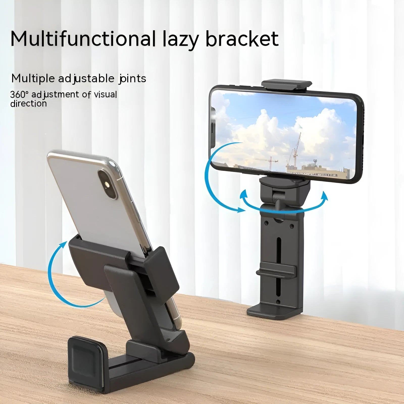 Black 360-degree rotating collapsible phone holder on desktop showing adjustable angle