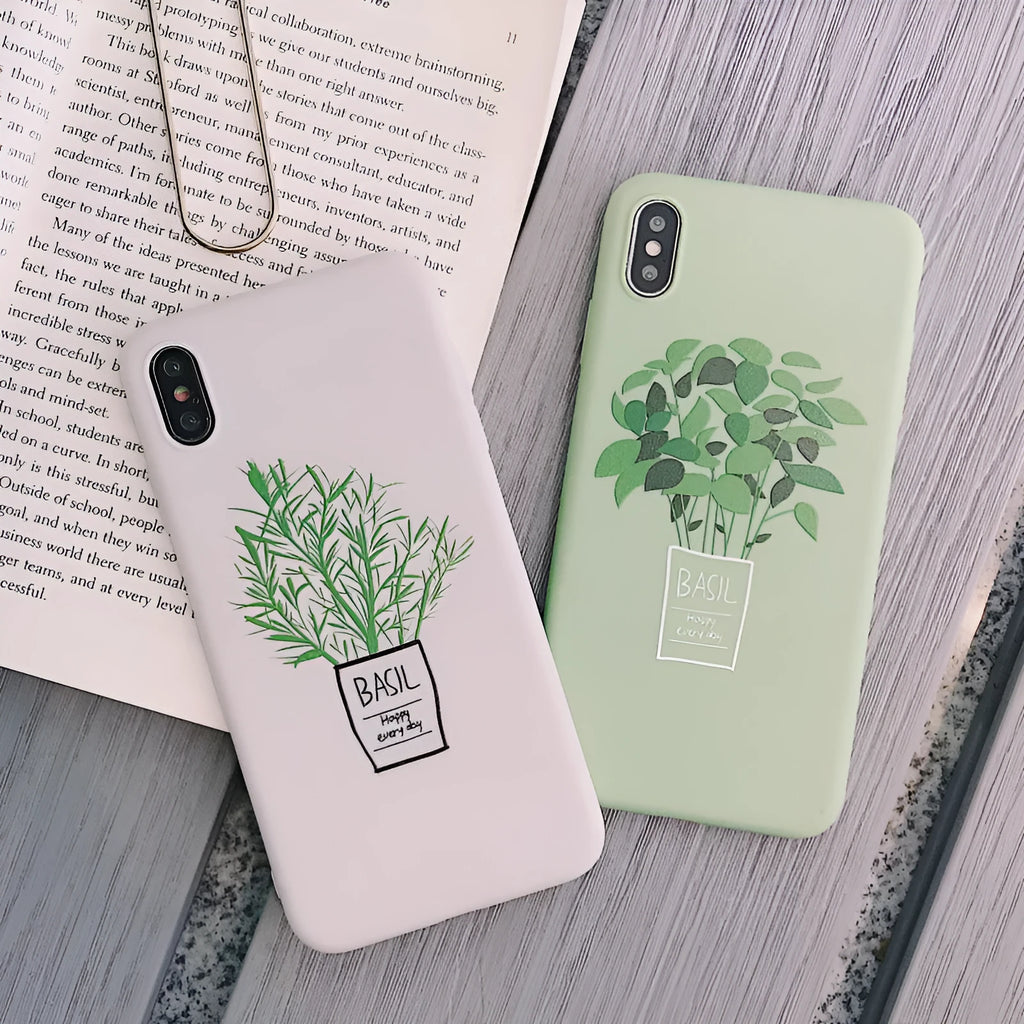 White silicone iPhone case with a detailed painted leaf and plant pattern on the back.