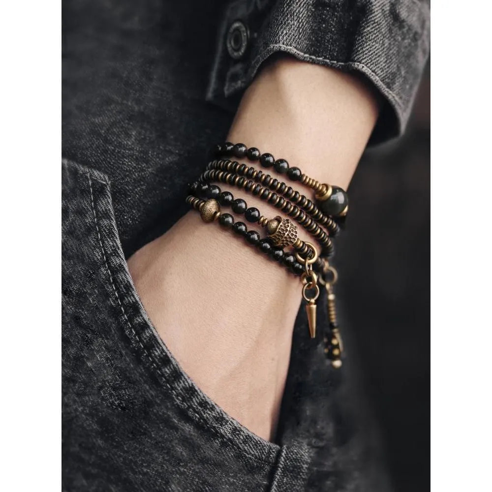 Black multi-layered beaded bracelet with colourful geometric and natural style beads.