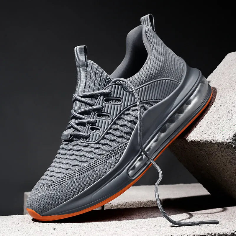 Black low-top mesh running sneakers with rubber sole, showing breathable construction and lace-up front