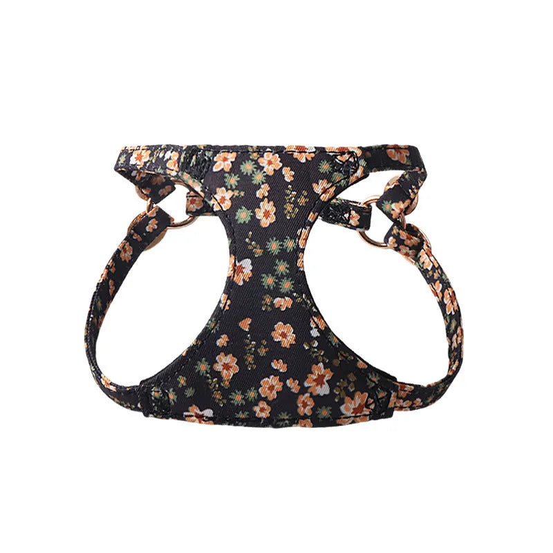 Floral pattern cloth dog harness and leash set shown in small size on a model.