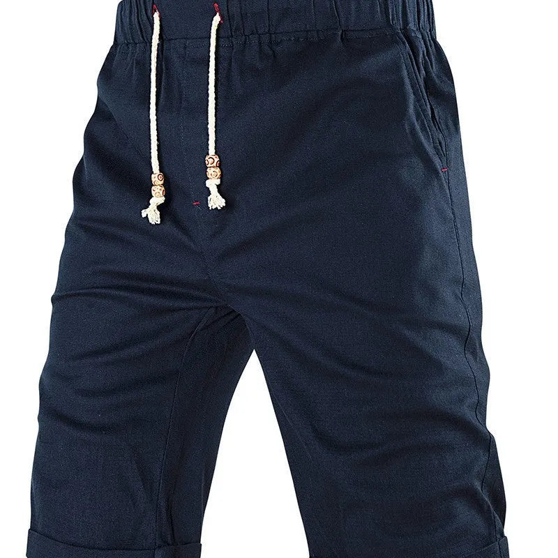 Men's solid colour cotton blend sports shorts with drawstring waist and zipper pocket.