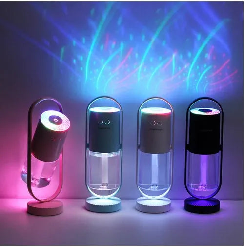 Pink USB portable air humidifier with projection night light on a wooden desk
