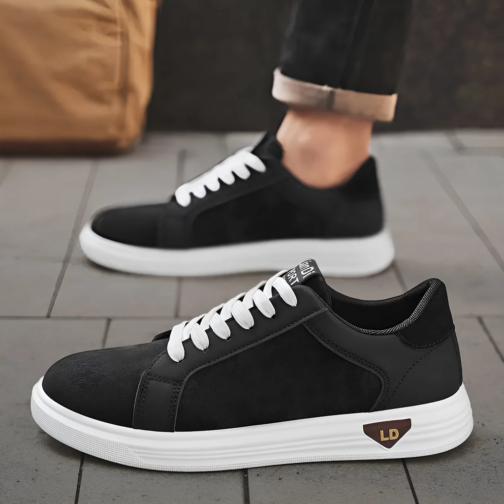 Men's black snake pattern PU leather casual sneakers with round toe and rubber sole on a white background.