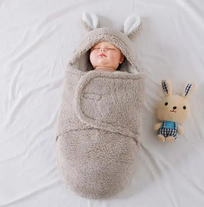 Baby wearing adjustable cotton swaddle sleep sack with velcro closure