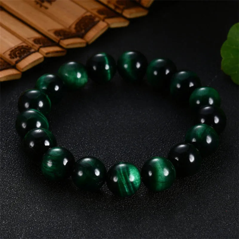 Green tiger eye stone bracelet with geometric beads in hand-polished finish showing natural colour banding