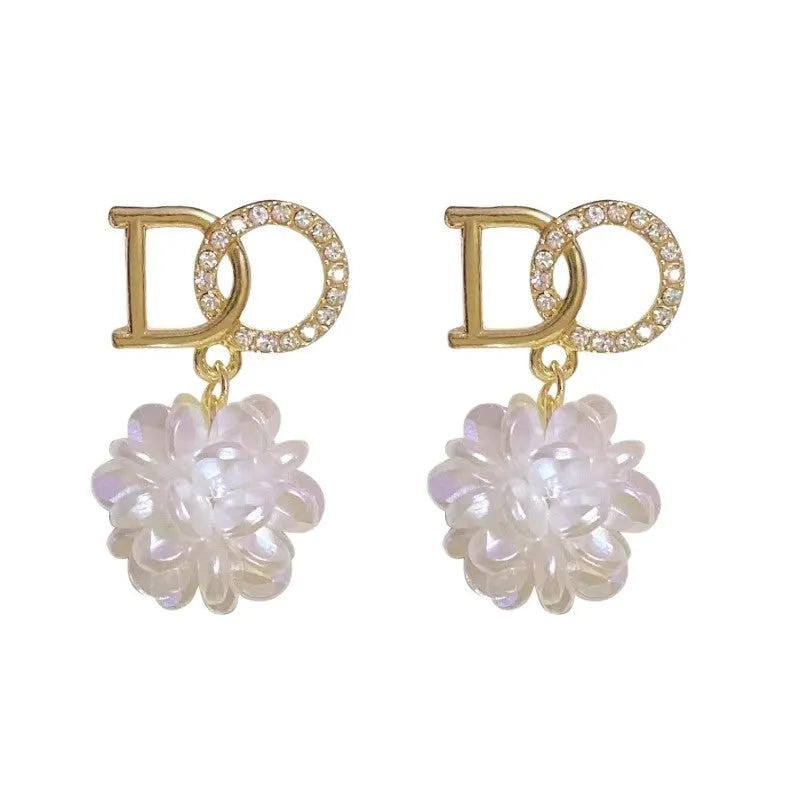 White DO letter embroidered ball earrings for women, trendy drop style with letter and ball detail.