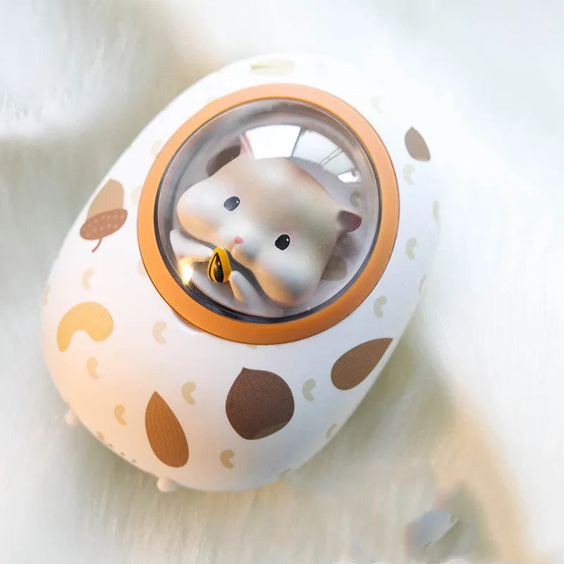 White hamster hand warmer power bank with space capsule design showing heating controls and USB ports