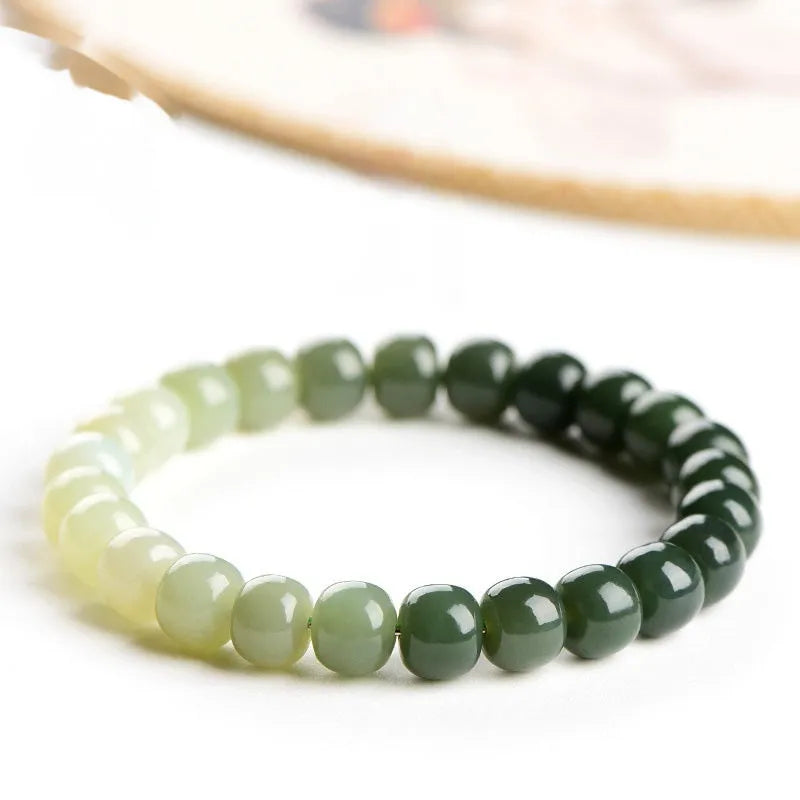 Natural Hetian jade bracelet with gradient clear water colours showing polished beads