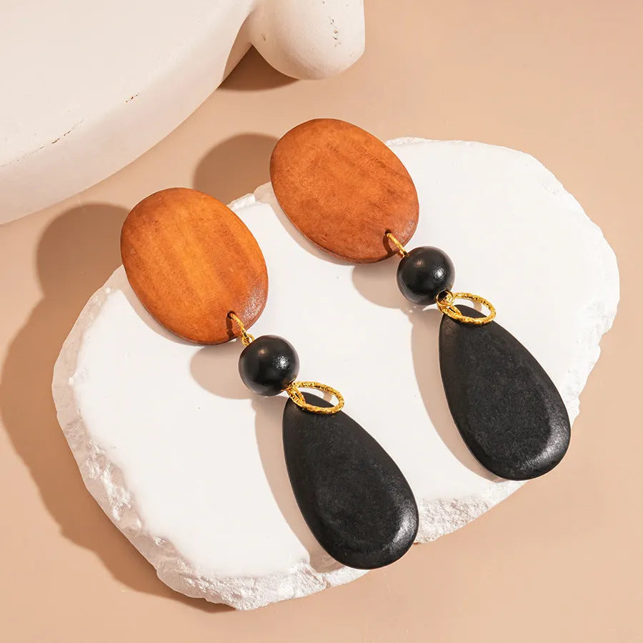 Handcrafted wooden earrings with elliptical design in silver brown black colours
