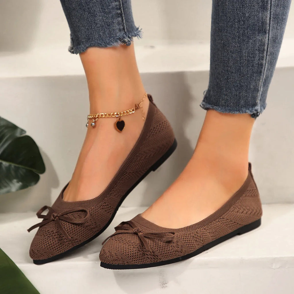 Women's knitted bow loafers with pointed-toe design in multiple colour options showing flat heel and rubber sole