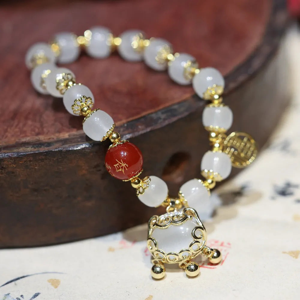 Chinese style coloured glaze bracelet with glass safety lock charms and windmill bead design