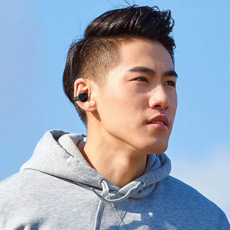 Black wireless Bluetooth clip-on bone conduction earphones showing clip mechanism and compact design