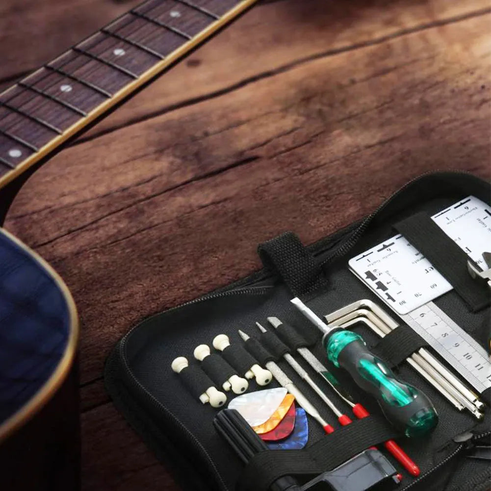 Black guitar repair kit case open showing metal and plastic tools including truss rod wrench, fret files, and string winder