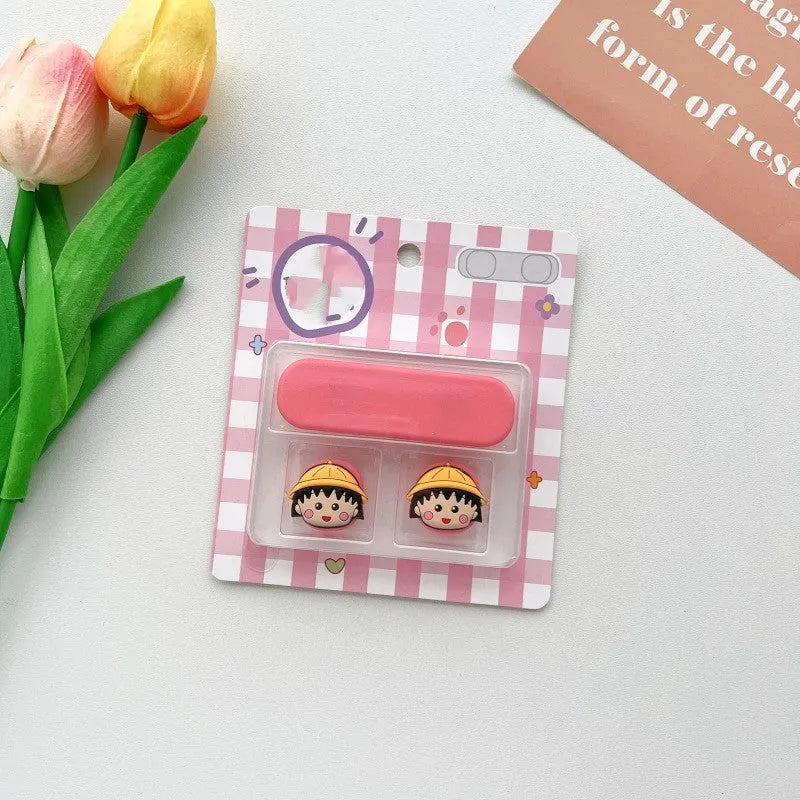 Cartoon-style magnetic plastic cable fixer clip in various colours on a metallic desk surface.