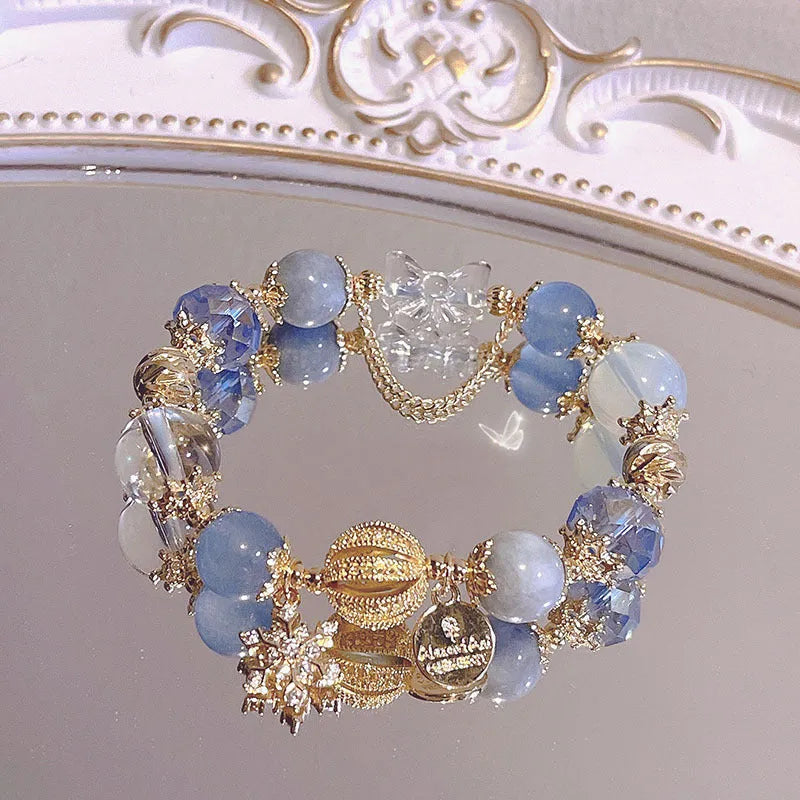 Galaxy-coloured women's alloy bracelet with snowflake pendant and bow charm.
