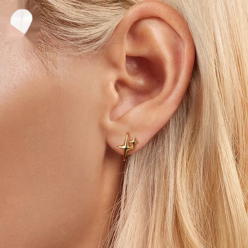 Minimalist star design sterling silver ear clips with oxidation finish and clip-on back.