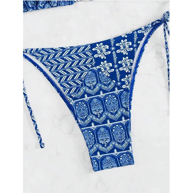 Women's green bandage-style split bikini swimsuit with stitching detail on a mannequin.
