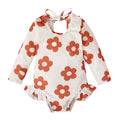 Girl's floral pattern open back swimsuit in polyester fabric showing crew neck design