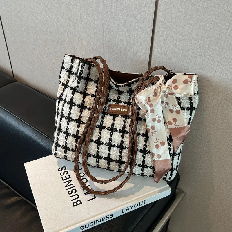 Black woolen shoulder bag with horizontal square shape showing internal organisation compartments