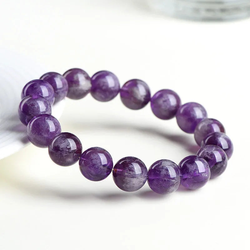 Natural feather amethyst crystal bracelet with scattered geometric beads showing purple crystal patterns and Ruyi elements