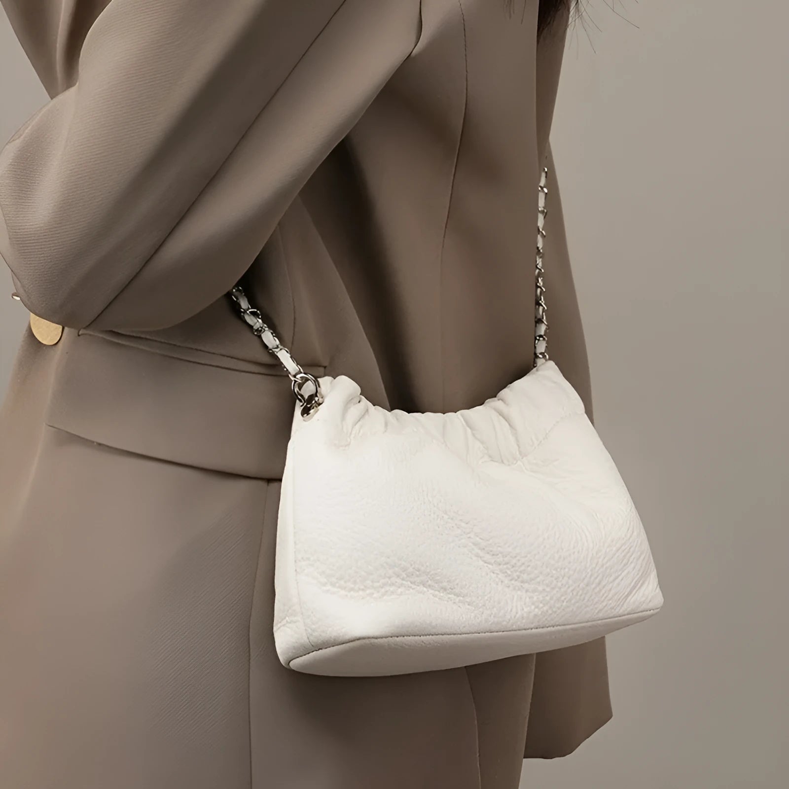 Women's genuine leather crossbody bag with chain strap in Black, Milky White, and Elephant Grey colours.