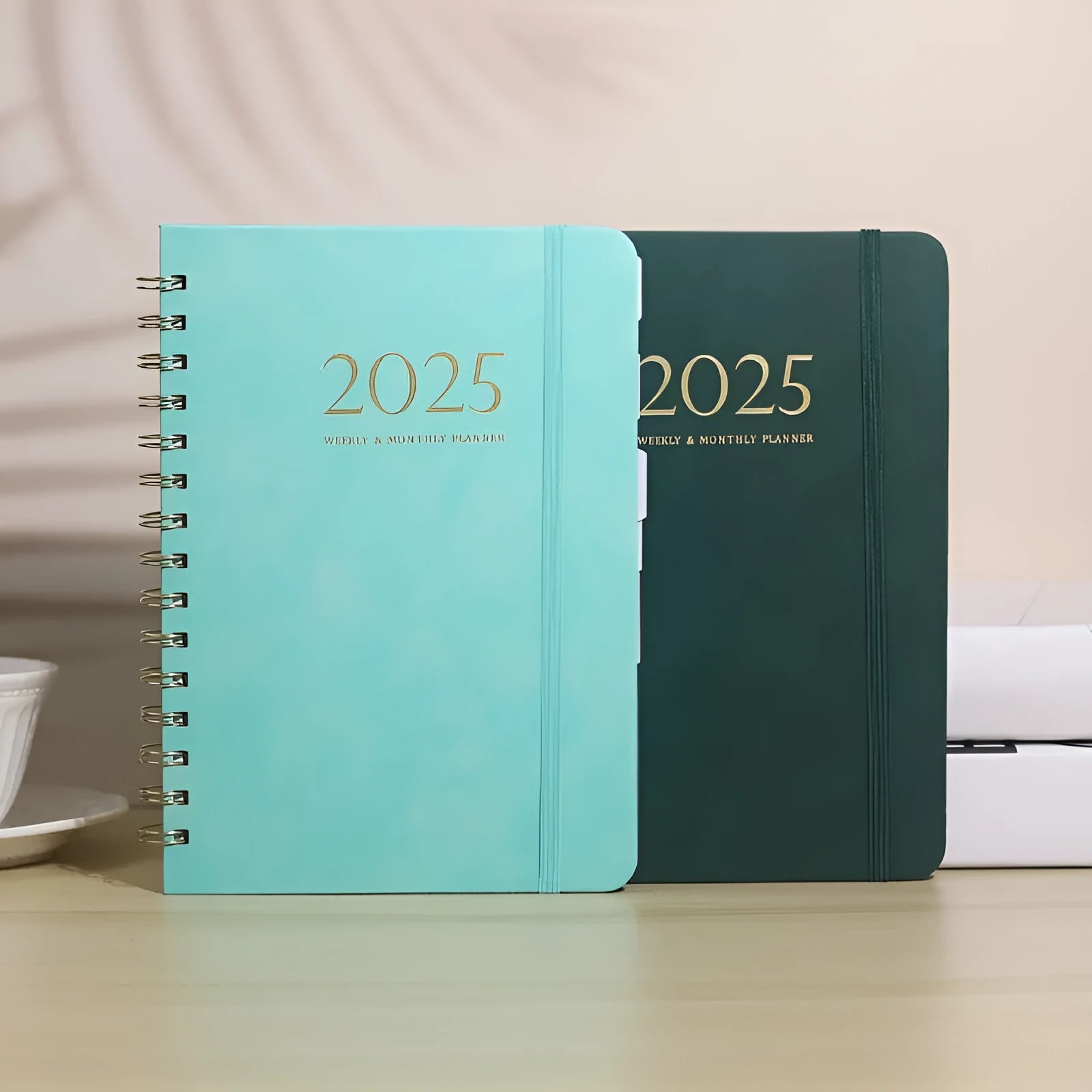 A5 size PU leather notebook with metal coil binding, shown in a choice of cover colours including black, brown, blue, and pink.