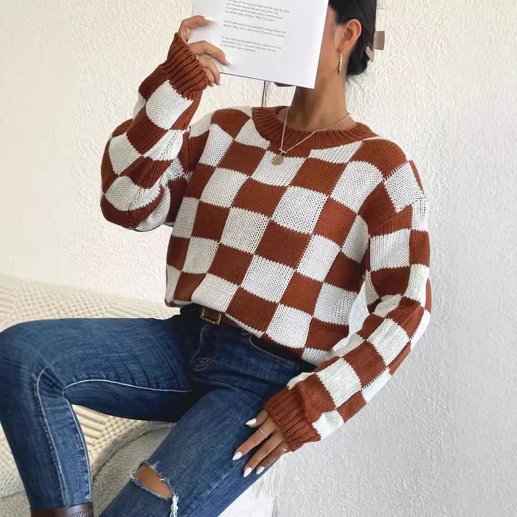 Dark brown plaid pattern pullover sweater with long sleeves and round neck, laid flat showing full design