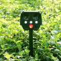 Green solar ultrasonic dog repeller with solar panel, measuring 12x13x5cm for outdoor pest control