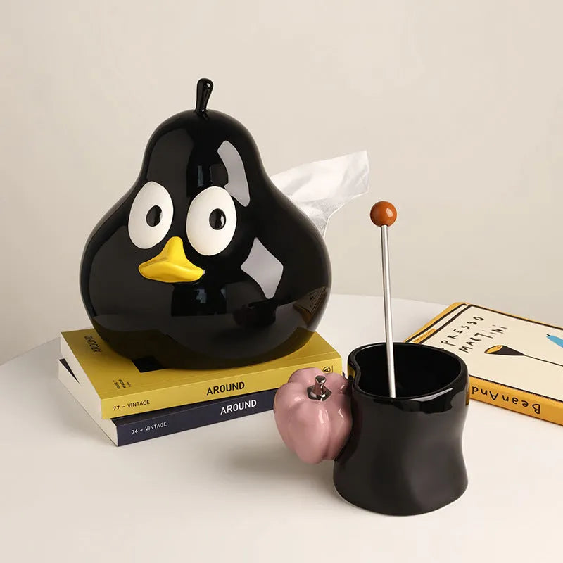 Green ceramic pear tissue box with animal style design on a wooden desktop