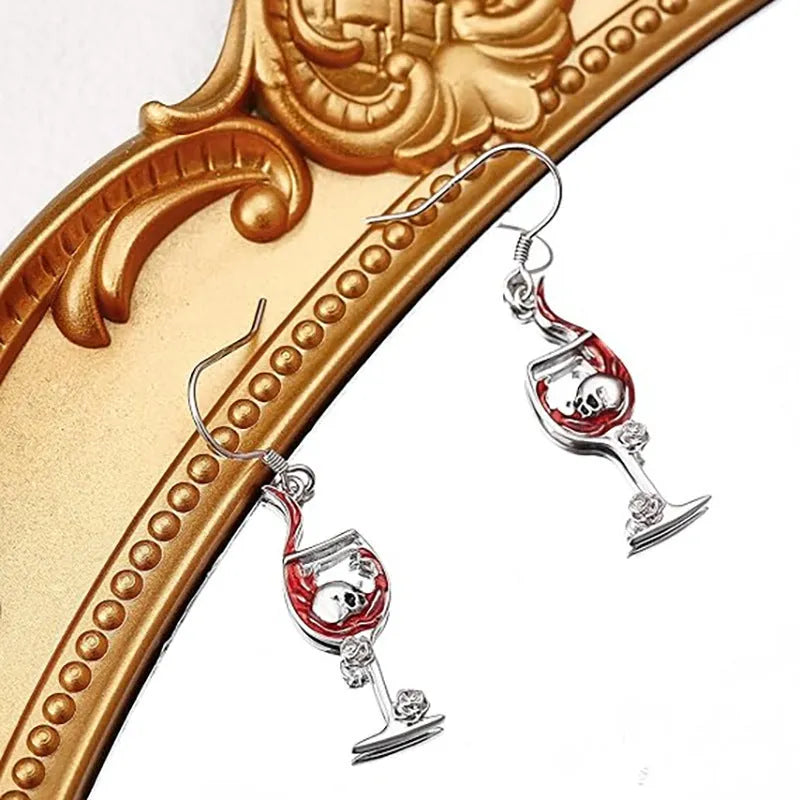 Close-up of zinc alloy Halloween earrings featuring a combined skull and wine glass design with an electroplated metallic finish.