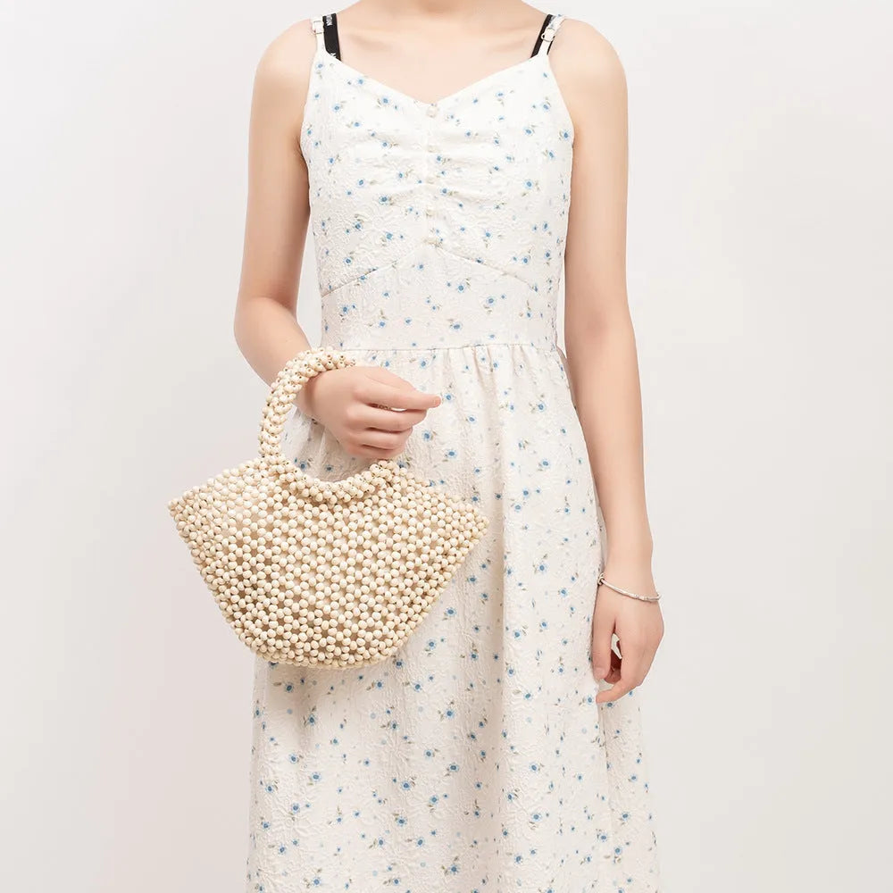 Hand-woven maple wood beach bag with wooden beads in dumpling shape.