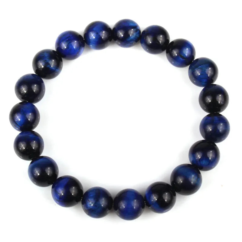 Natural tiger eye crystal bracelet with round beads in dark blue colour, showing tiger eye banding patterns