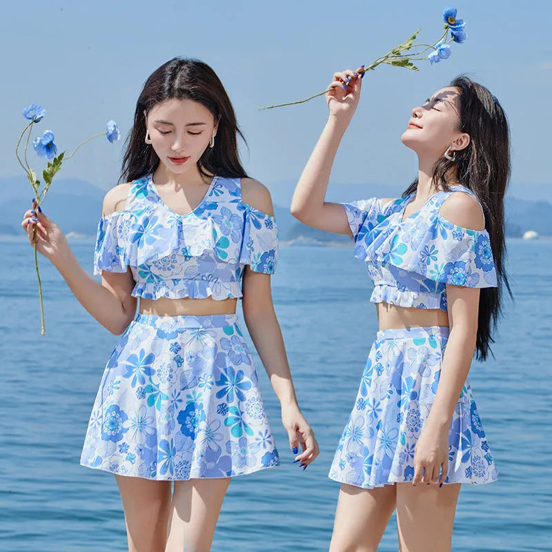 Blue floral patterned women's one-piece swim dress on hanger