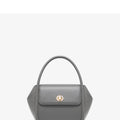 Leather tote cross-body wing bag in soft cow leather with latch closure and wing shape design.