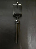 Black desktop phone holder with adjustable two-section bracket on weighted base holding smartphone