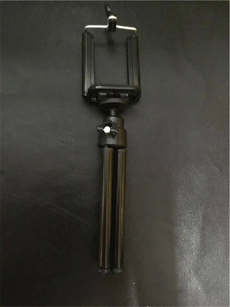 Black desktop phone holder with adjustable two-section bracket on weighted base holding smartphone