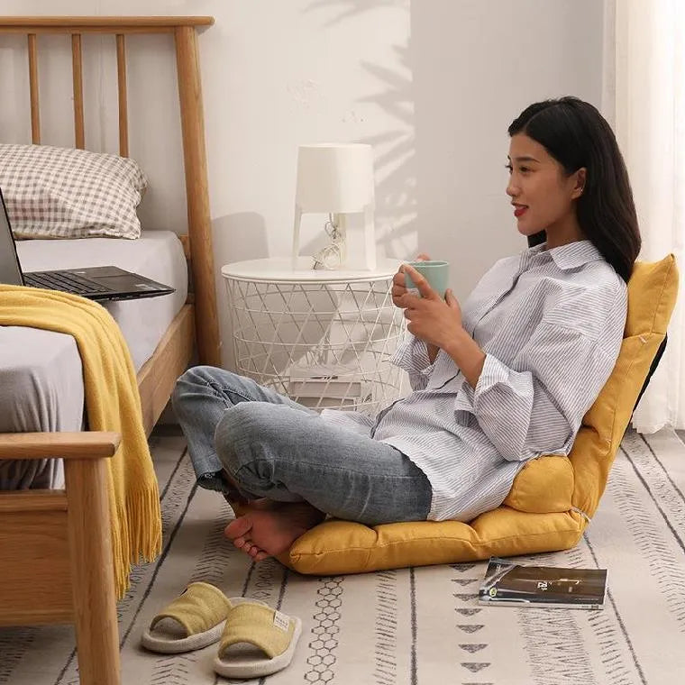Beige adjustable backrest lazy sofa floor chair folded flat showing fabric texture and reclining mechanism