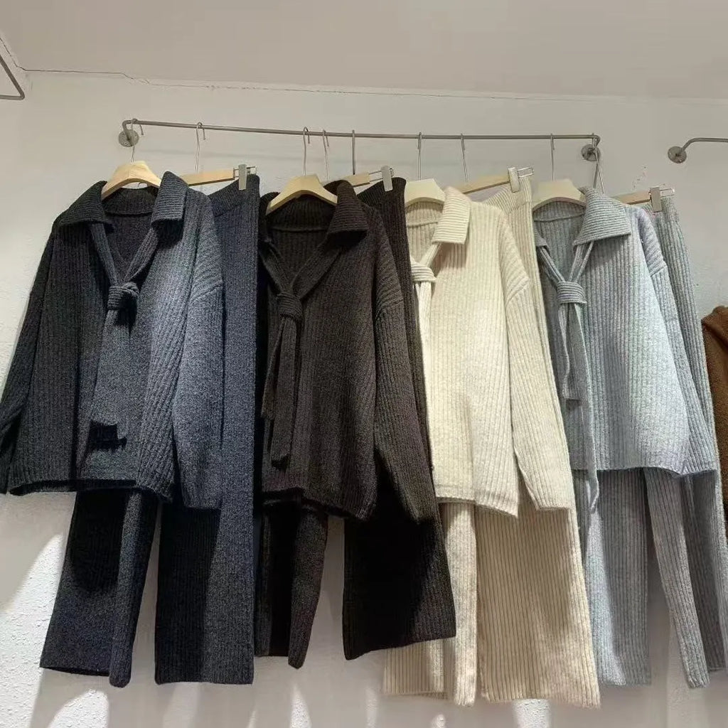 Dark grey sweater suit two-piece set with knit top and trousers showing collage stitching detail