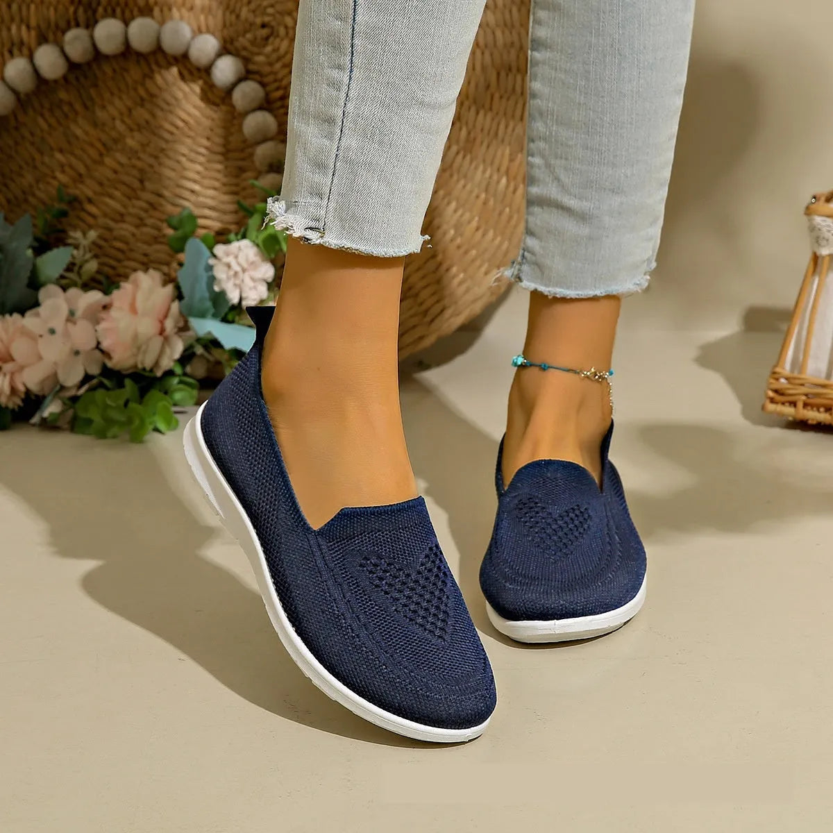 Women's plus size beige slip-on cloth shoes with low-cut design and flat sole.