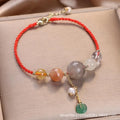 Women's hand-woven crystal and sequin bracelet with a silver peace buckle fastening on a wrist.