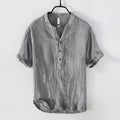 Retro-style short sleeve linen pullover top in a solid neutral colour on a hanger.